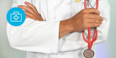 Doctor wearing a white coat and holding a red stethoscope