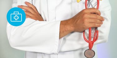 Doctor wearing a white coat and holding a red stethoscope