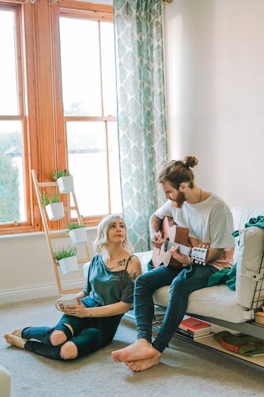 A married couple living within their means in a small apartment as they pay down student debt