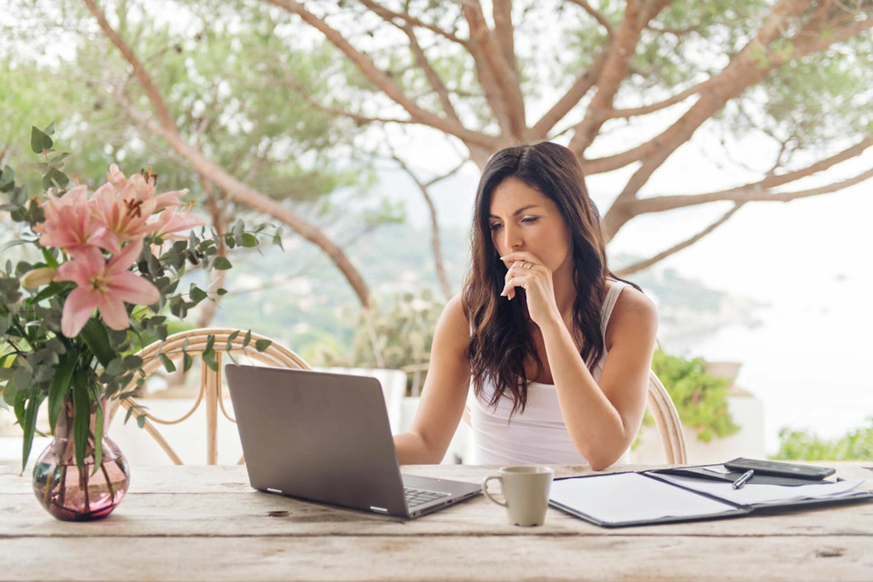 Woman uses laptop to access income protection insurance to protect her income