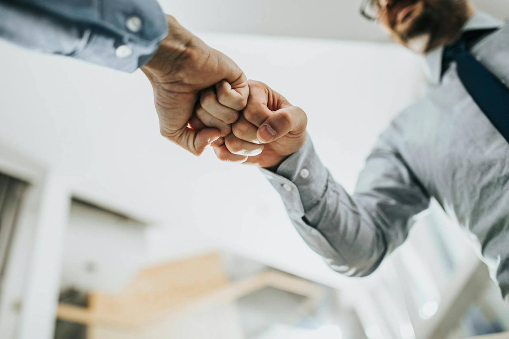Fist bump by two man who just finished a financial education class