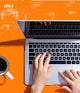 Image of a pair of hands on a laptop, with a coffee cup and notebook nearby, on an orange background