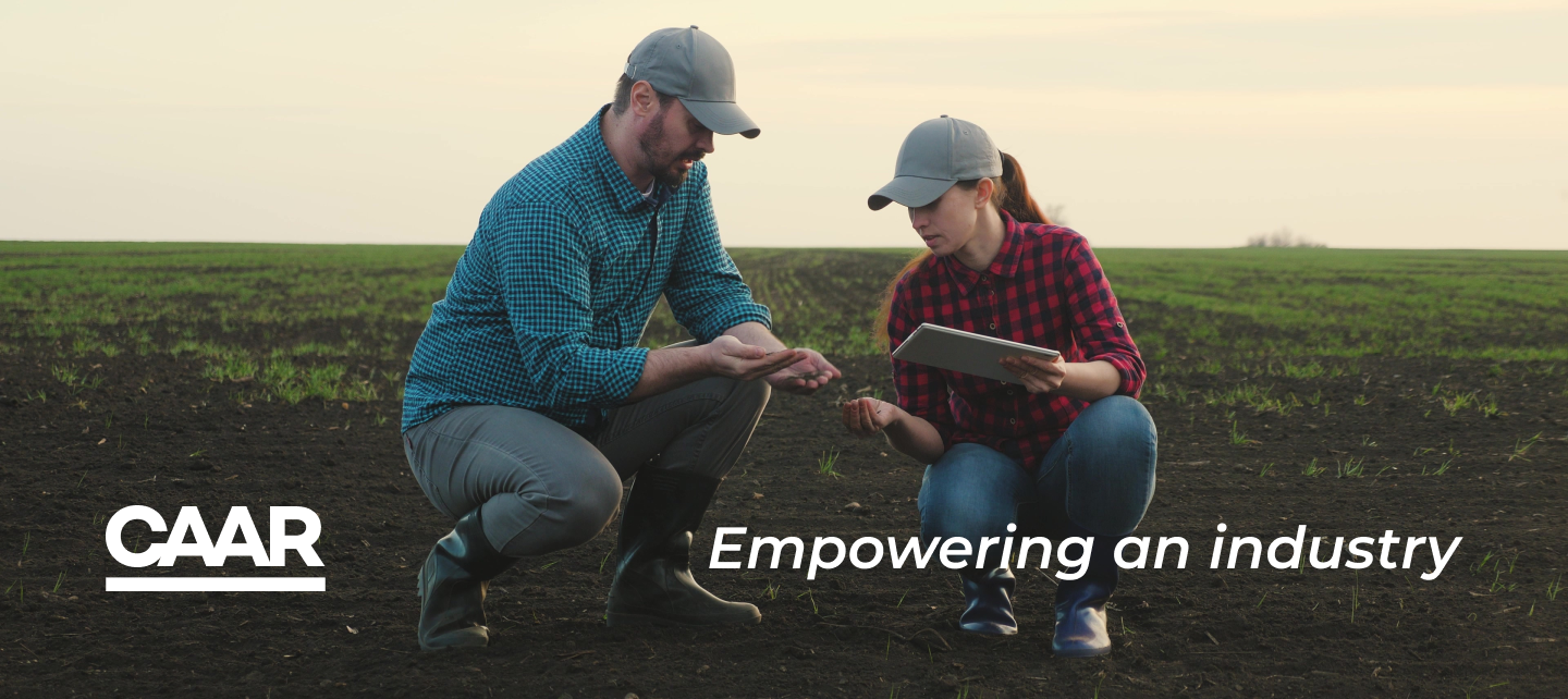 Image of two people looking at plants with the tagline: empowering an industry