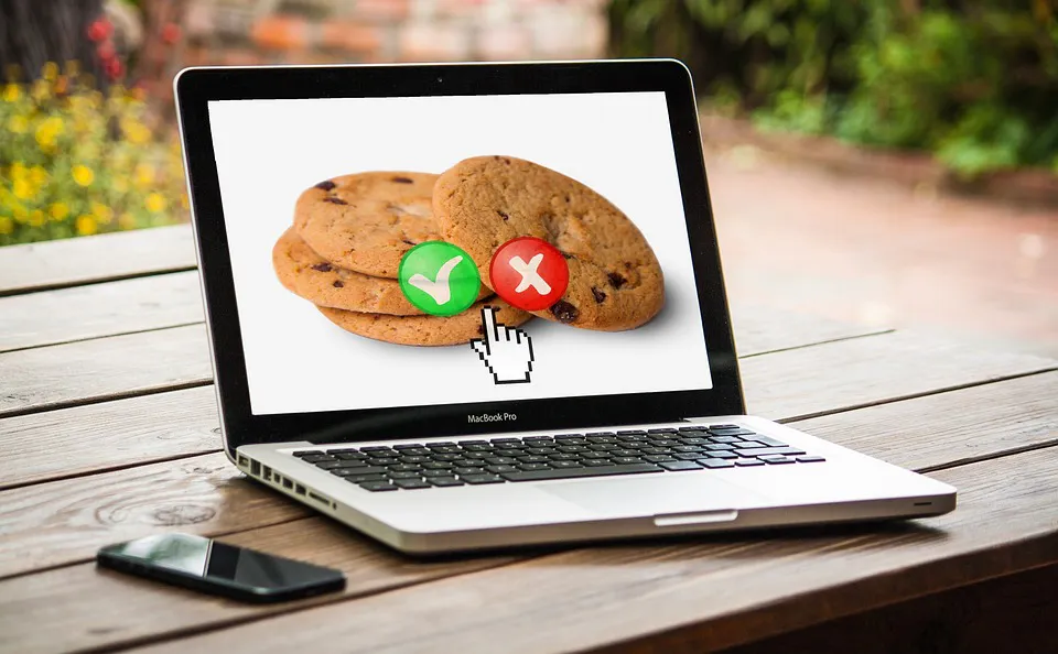 Laptop photo showing cookie icons with accept and reject buttons and a cursor pointer