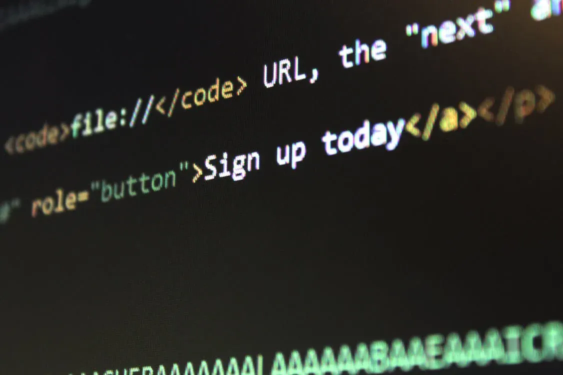 Close-up photo of HTML code on a screen with the words 