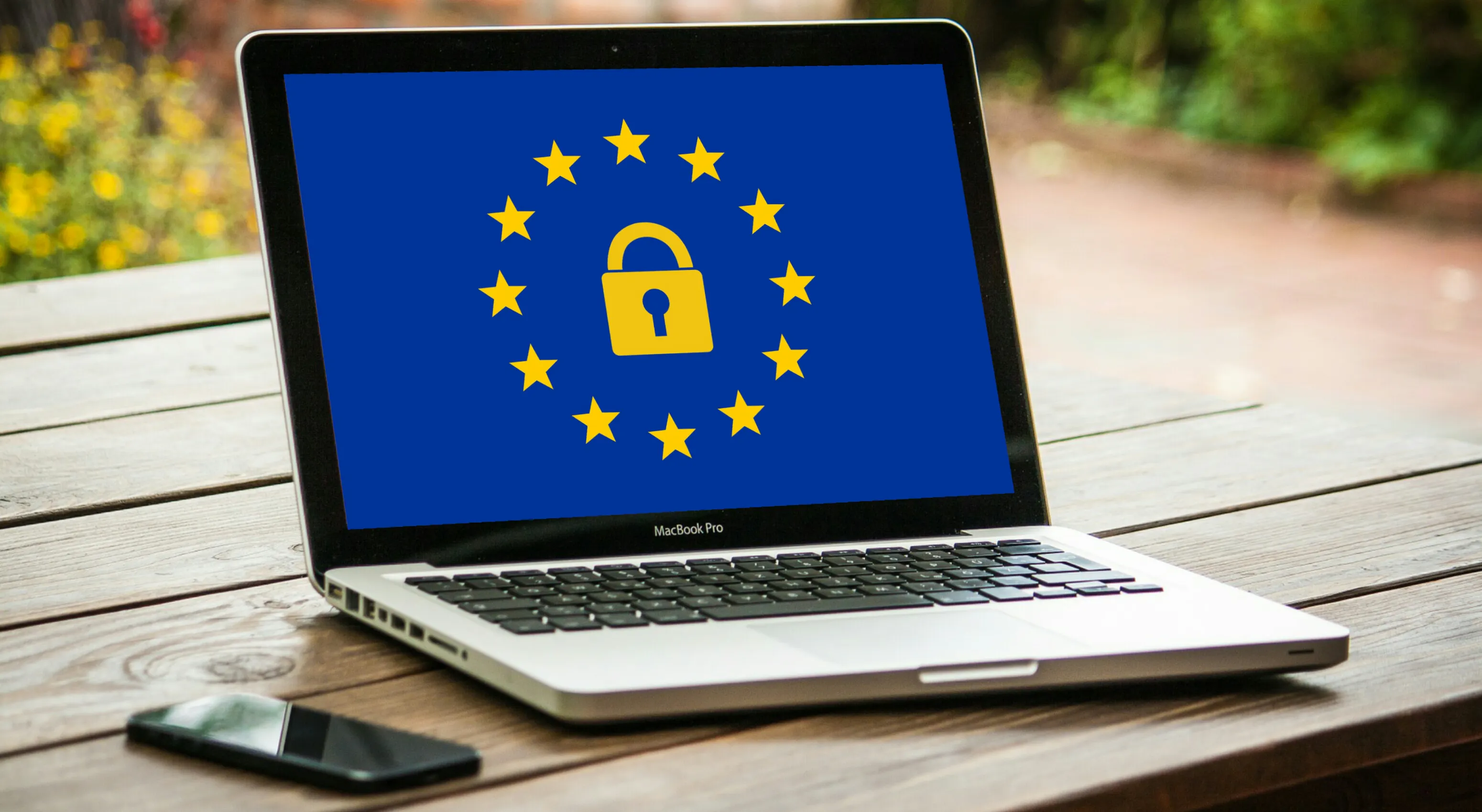 Laptop photo showing an EU flag with a padlock icon, representing GDPR data protection and compliance