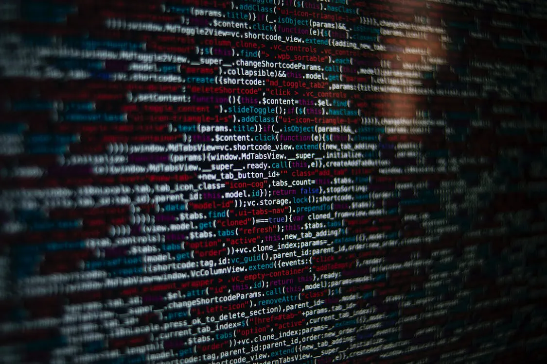Close-up photo of programming code on a screen with red and blue syntax highlighting