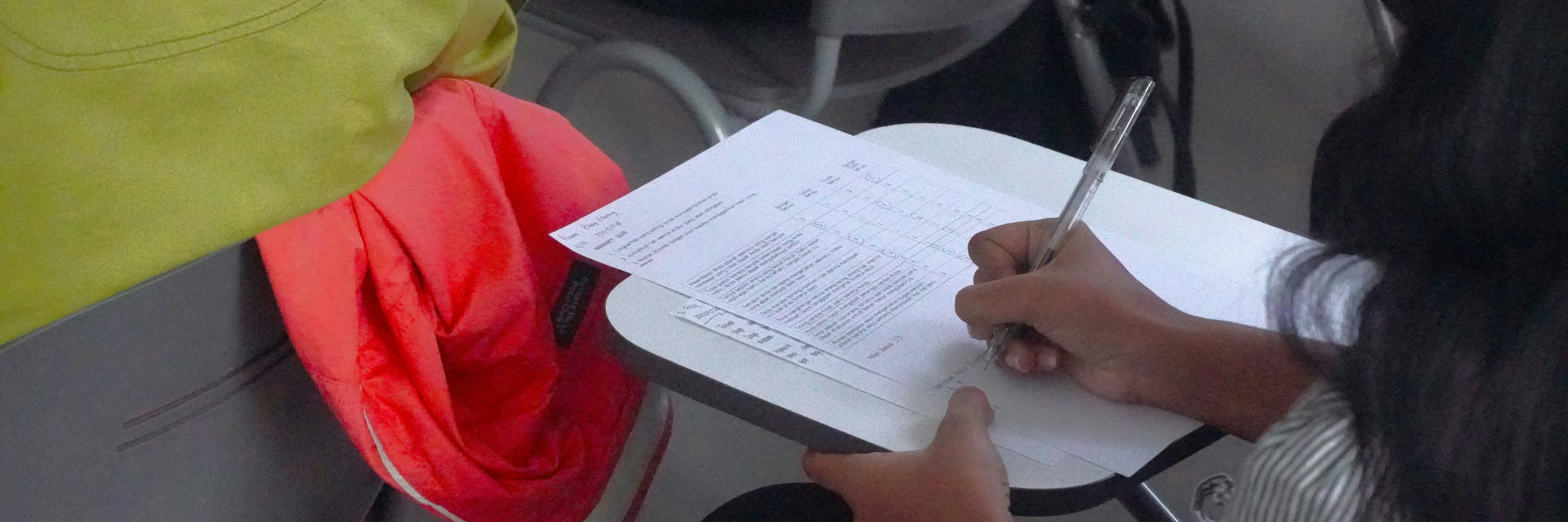 una persona che scrive su un pezzo di carta
