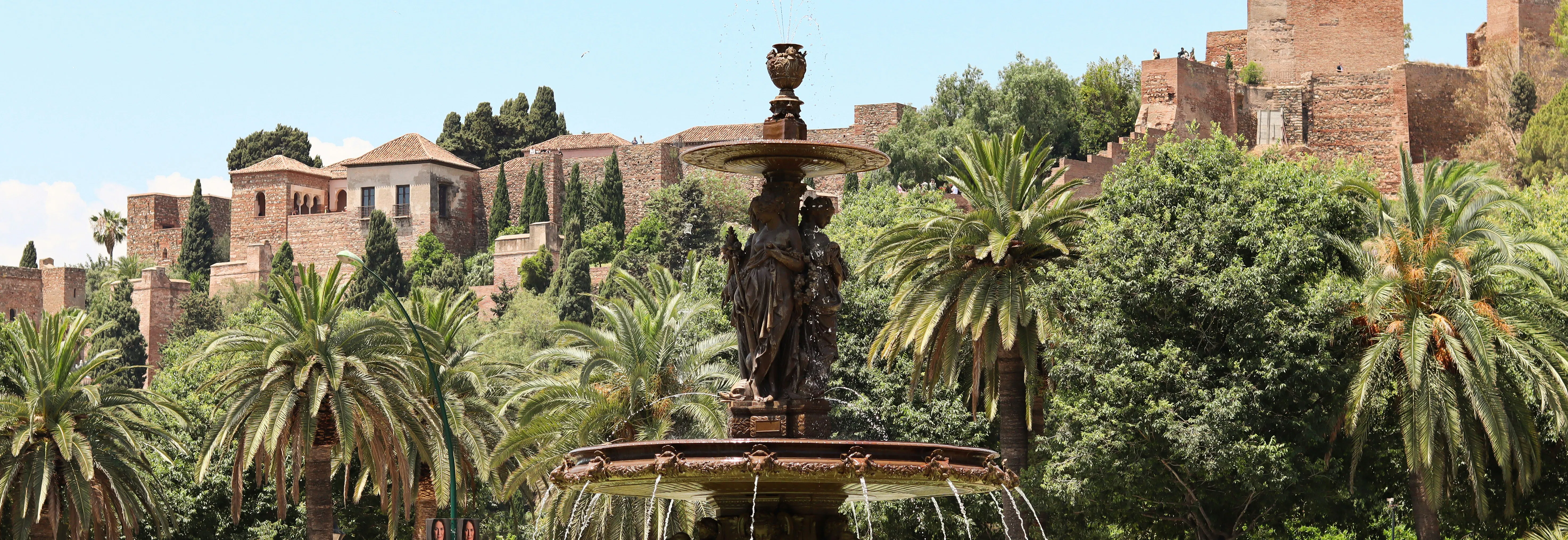 una fontana circondata da palme in un parco