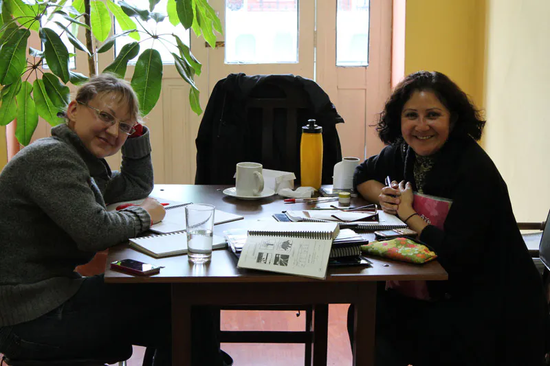 Studenti adulti che sorridono e lavorano insieme durante una lezione di gruppo