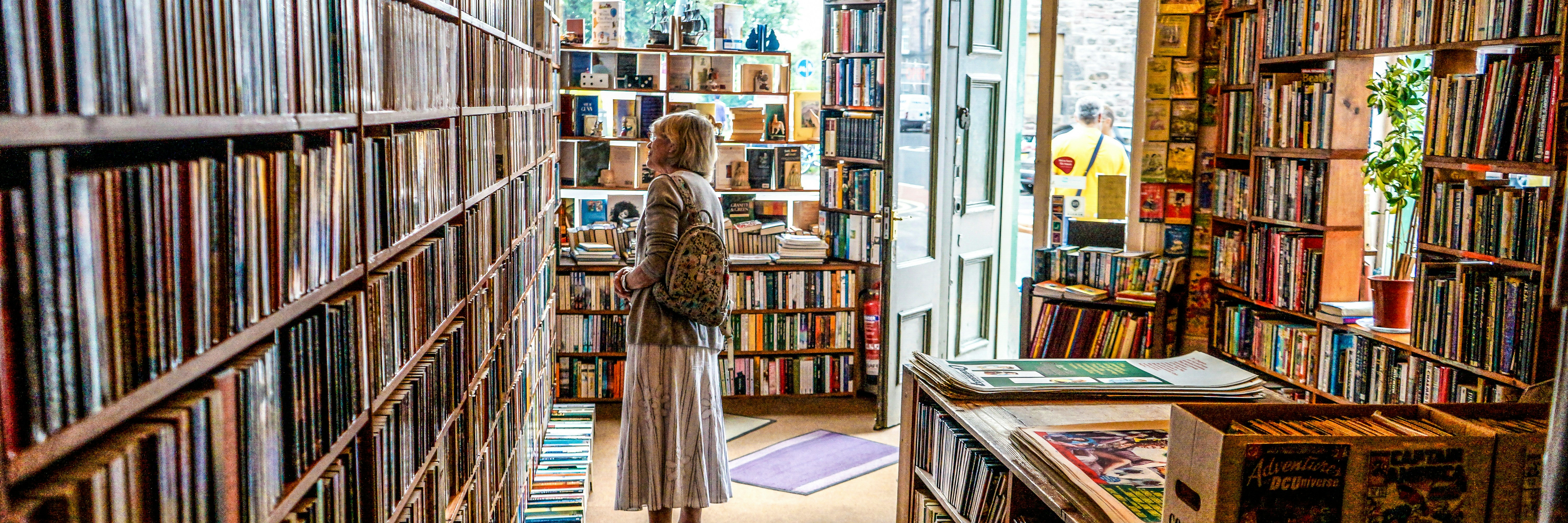 woman inside library looking at books