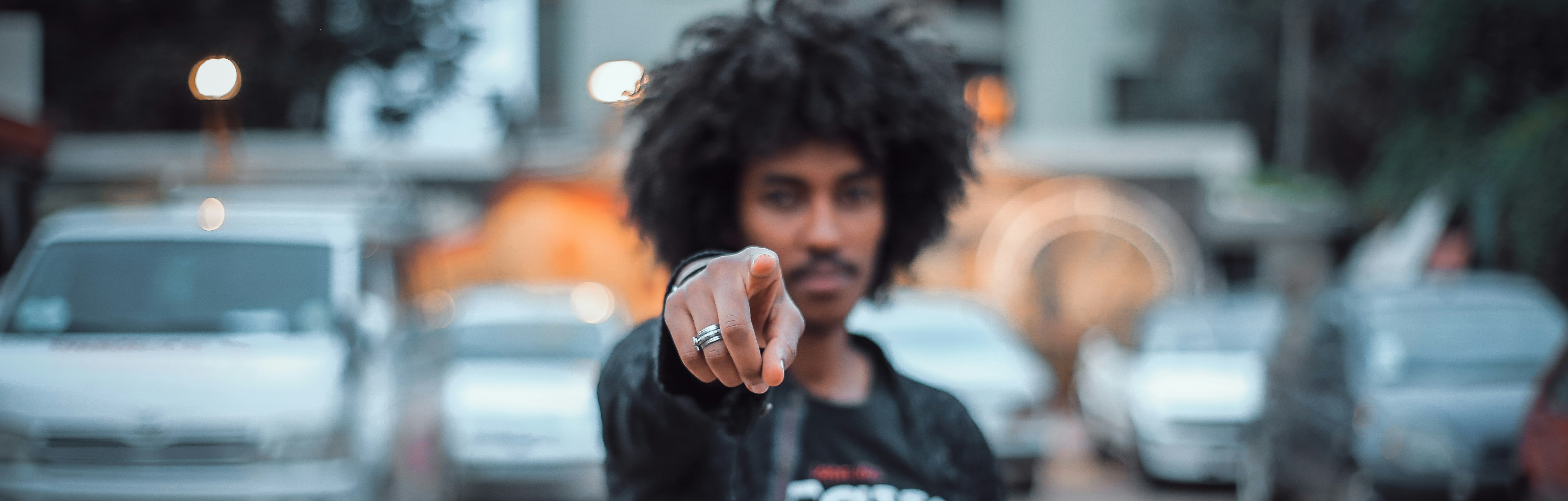 man pointing finger in front of camera