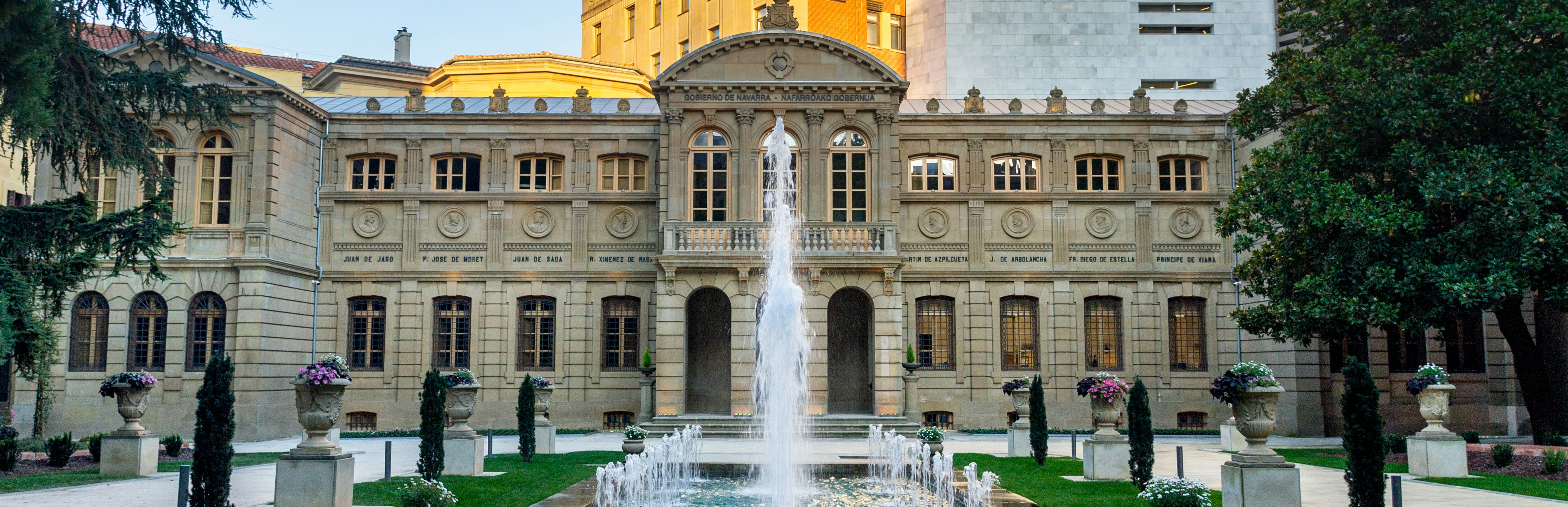 a large building with a fountain in front of it