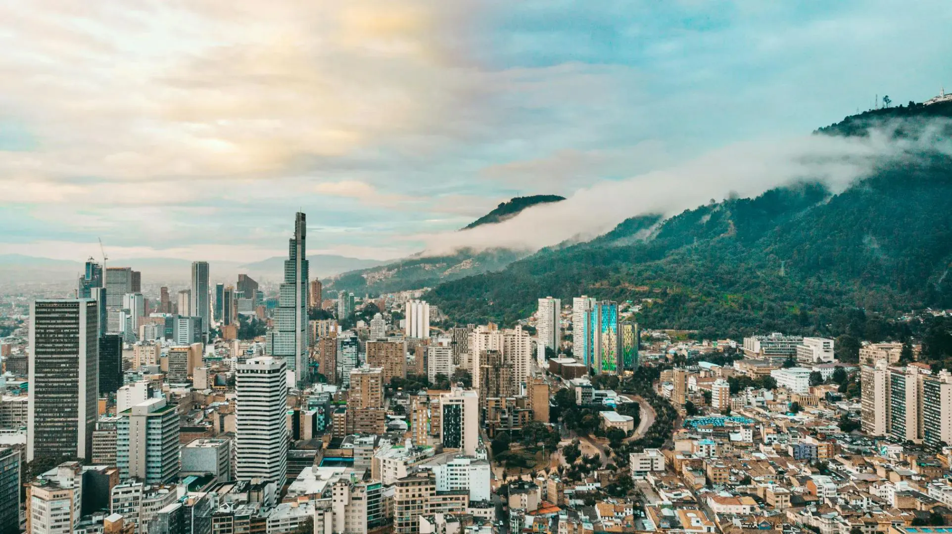 Vista panoramica di una grande città dell'America Latina circondata da montagne e edifici moderni