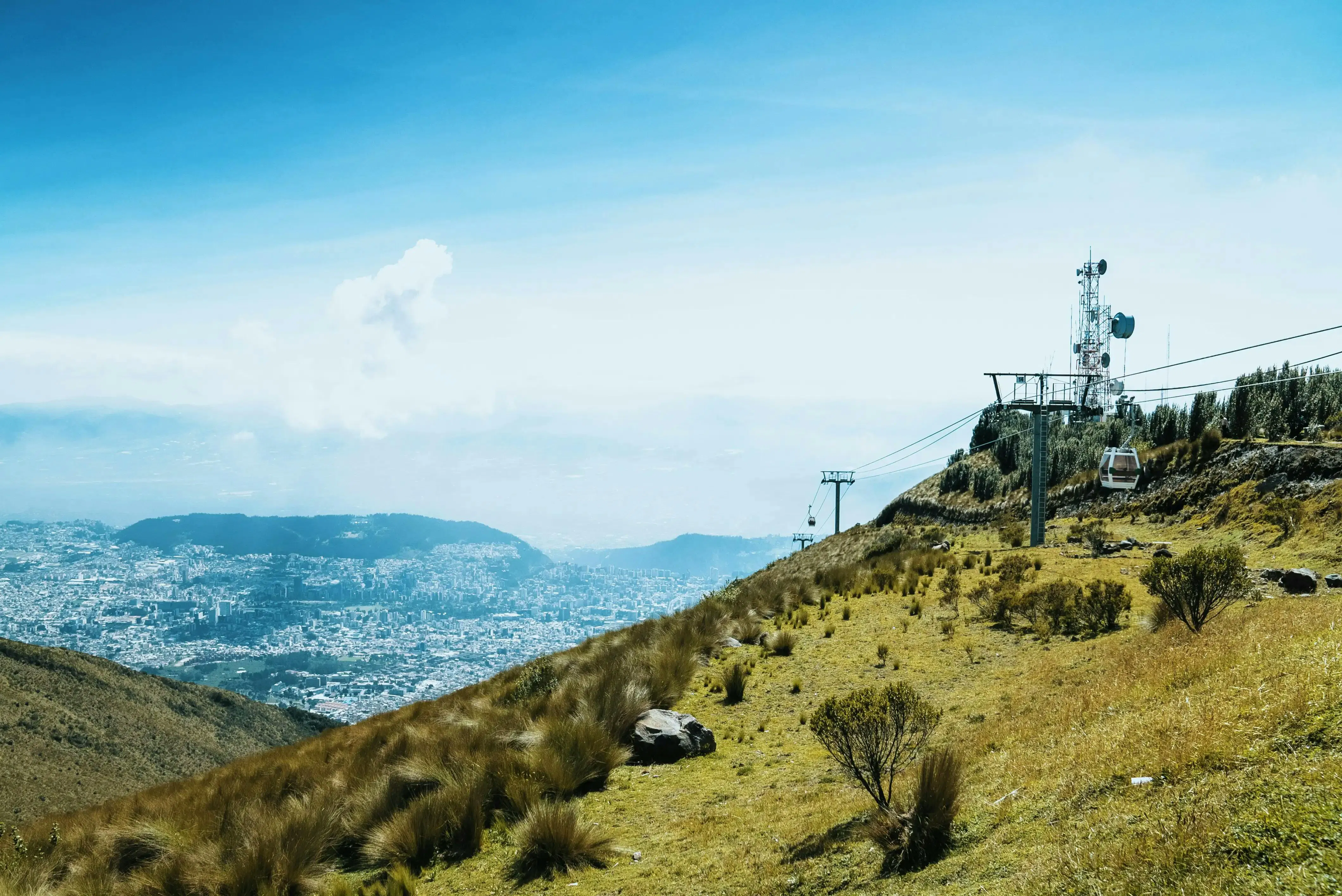 Paesaggio montano in Ecuador con colline verdi e un punto panoramico che domina la città