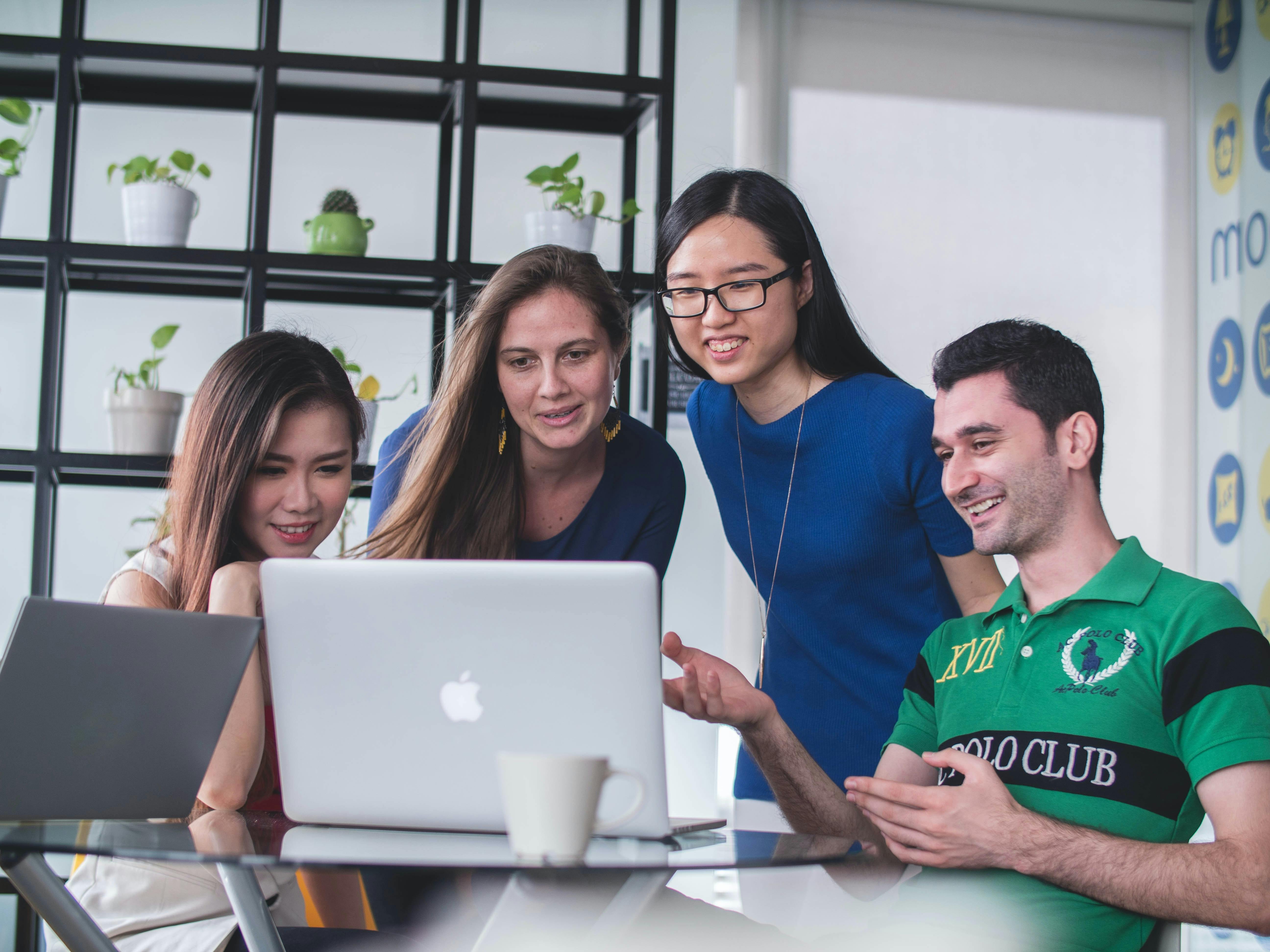 people discussing around a computer