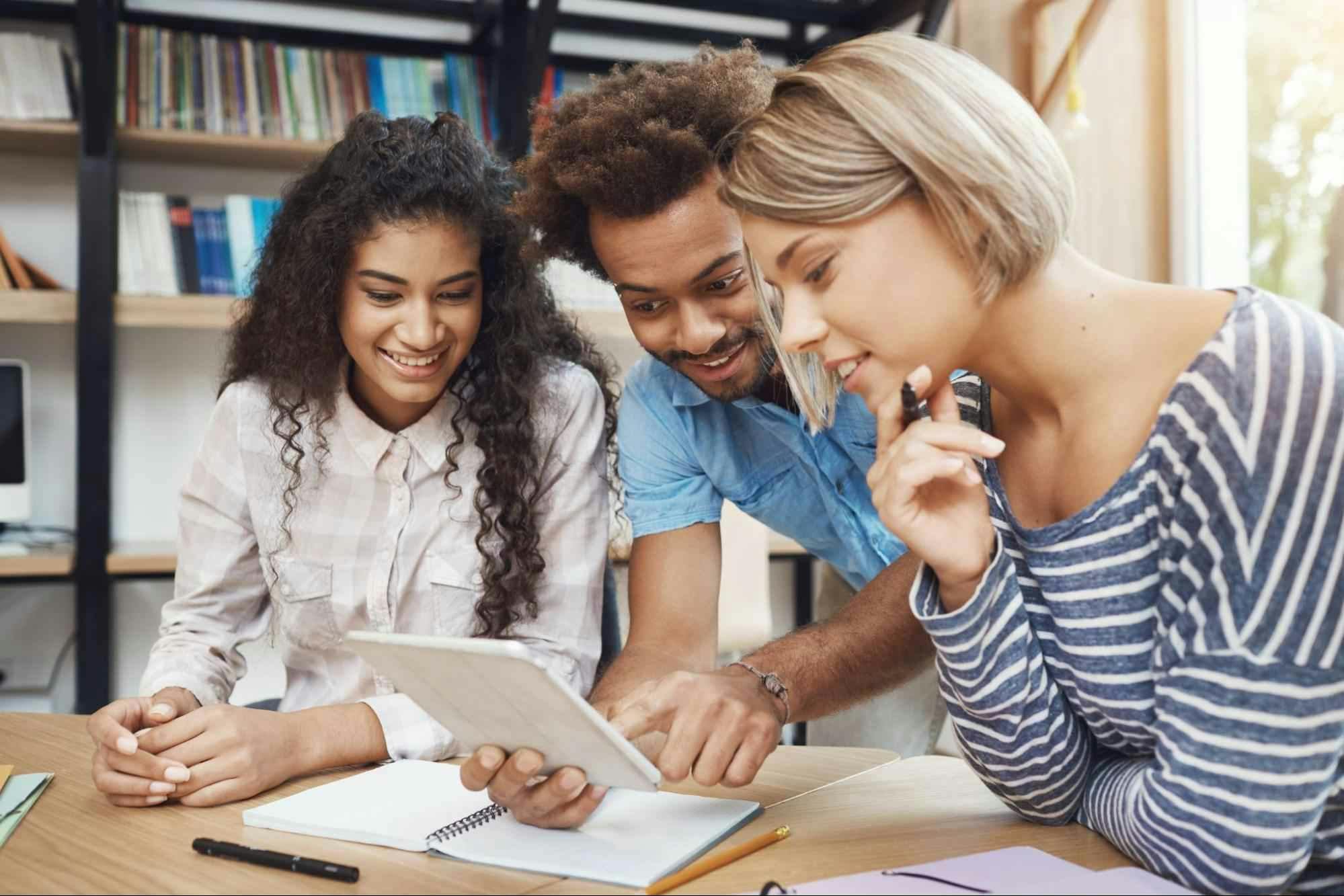 Pessoas reunidas em volta de um tablet