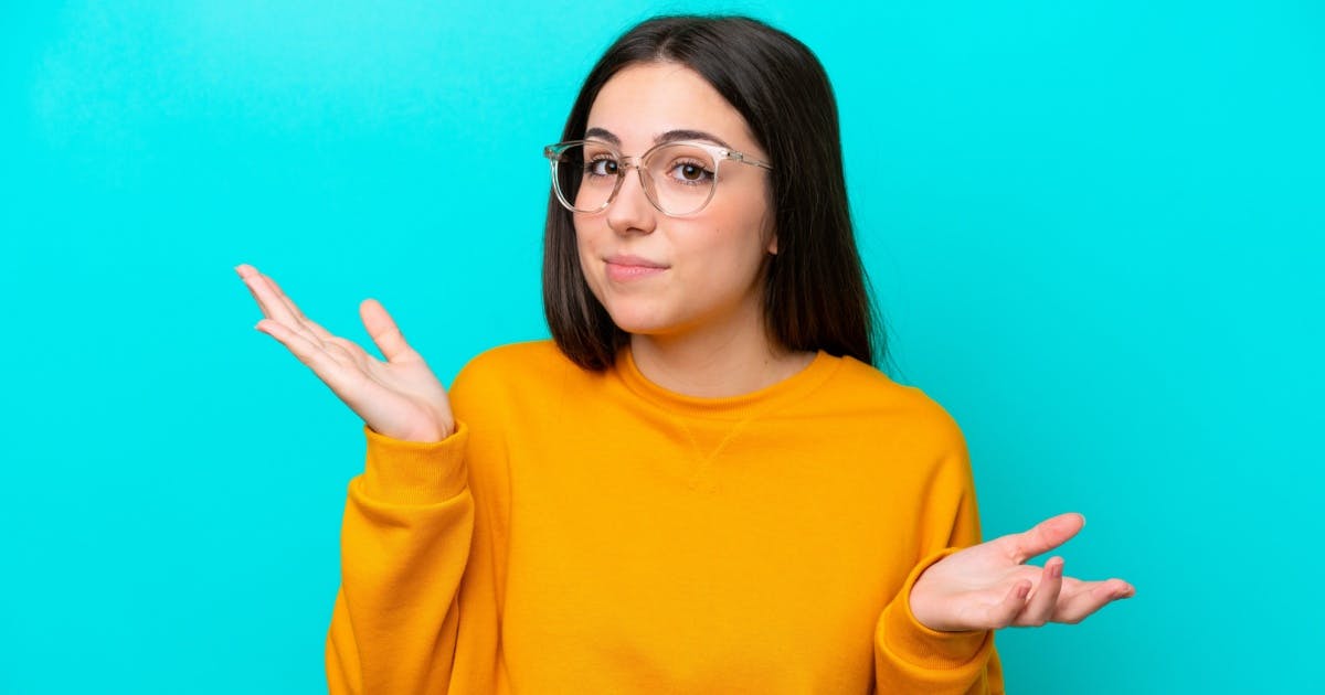 Mulher morena de óculos e com expressão de dúvida.