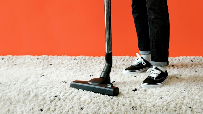 cleaner vacuuming a carpet