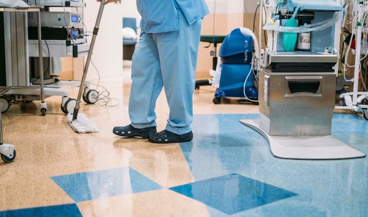 Woman mopping hospital floor