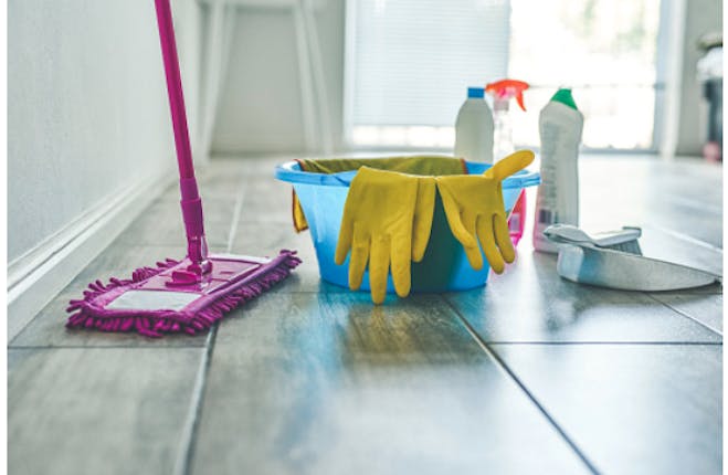Pink mop, blue bucket and yellow gloves, cleaning utensils for cleaning the house.