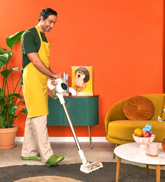 A housekeeper vacuuming the floor