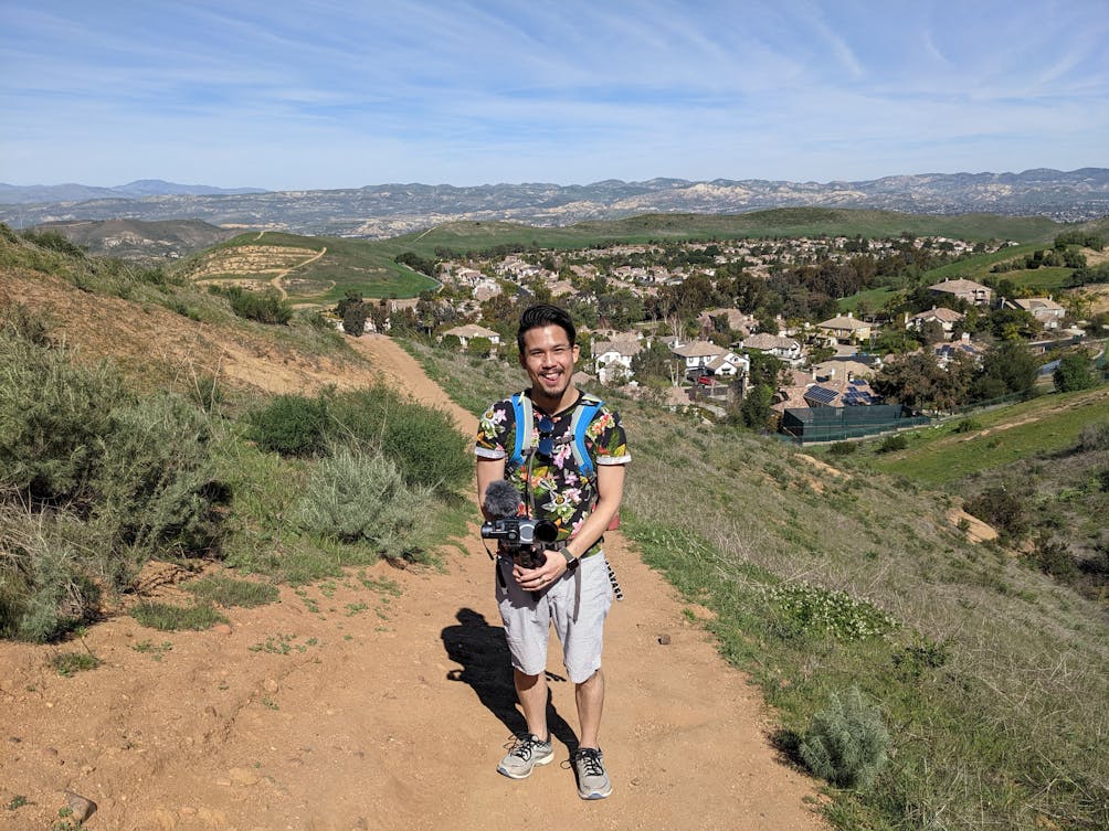 Hiker with his video camera smiling for a photo in Simi Valley at Woodridge Loop at Long Canyon in Simi Valley 