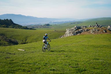 woman biking bolinas ridge trail bay area