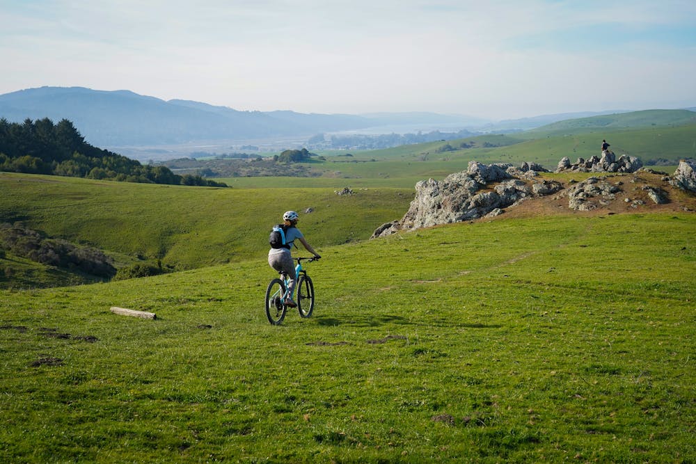woman biking bolinas ridge trail bay area