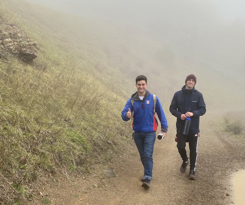 Two hikers on a misty trail at Mount Dialbo State Park 