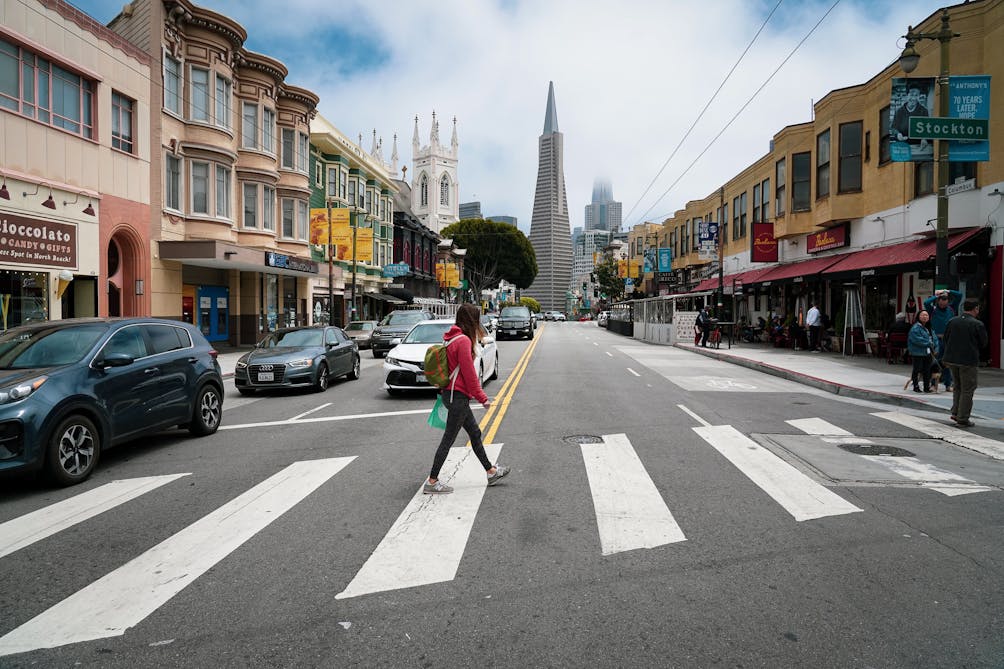 woman walking across street on Barbary Coast Trail in San Francisco