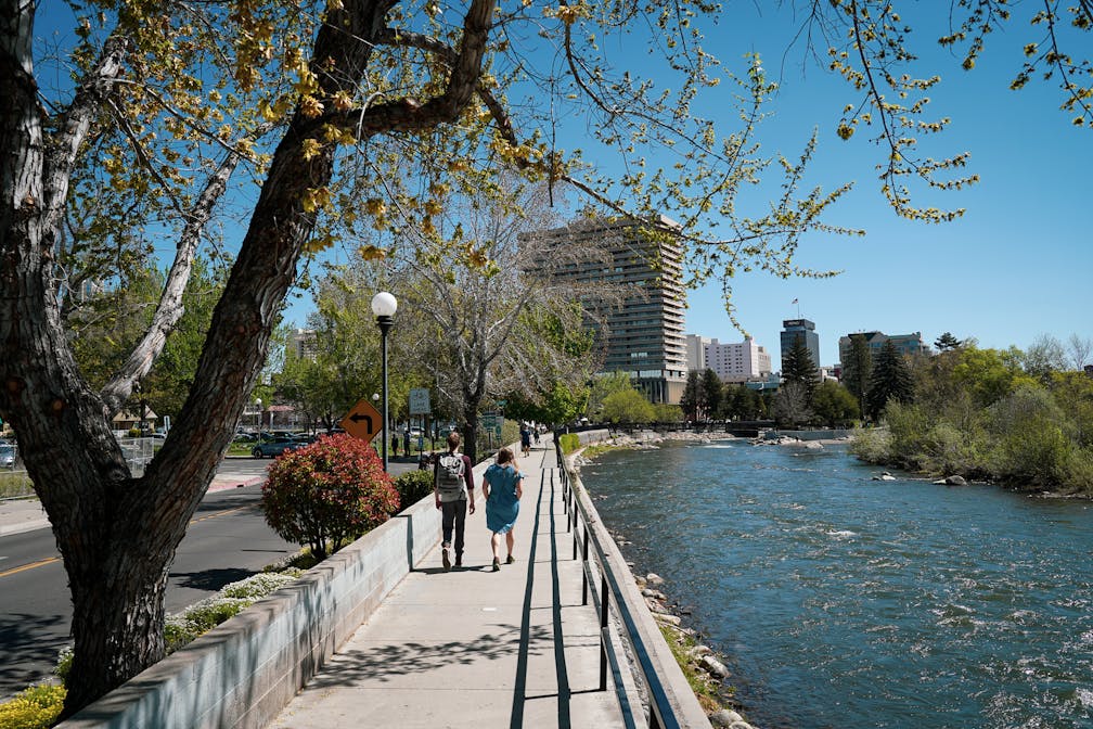 Couple walking the Reno Riverwalk along the Truckee River