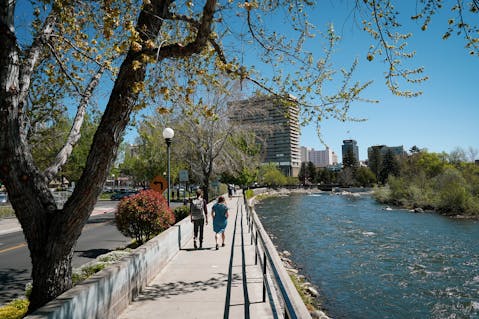 Couple walking the Reno Riverwalk along the Truckee River