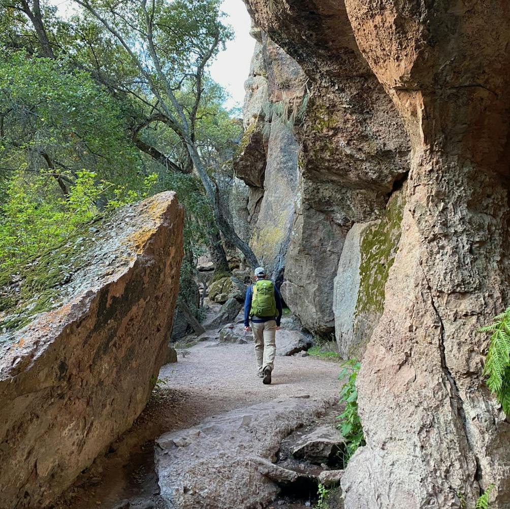 Person hiking near Bear Gulch Cave in Pinnacles National Park near Monterey 