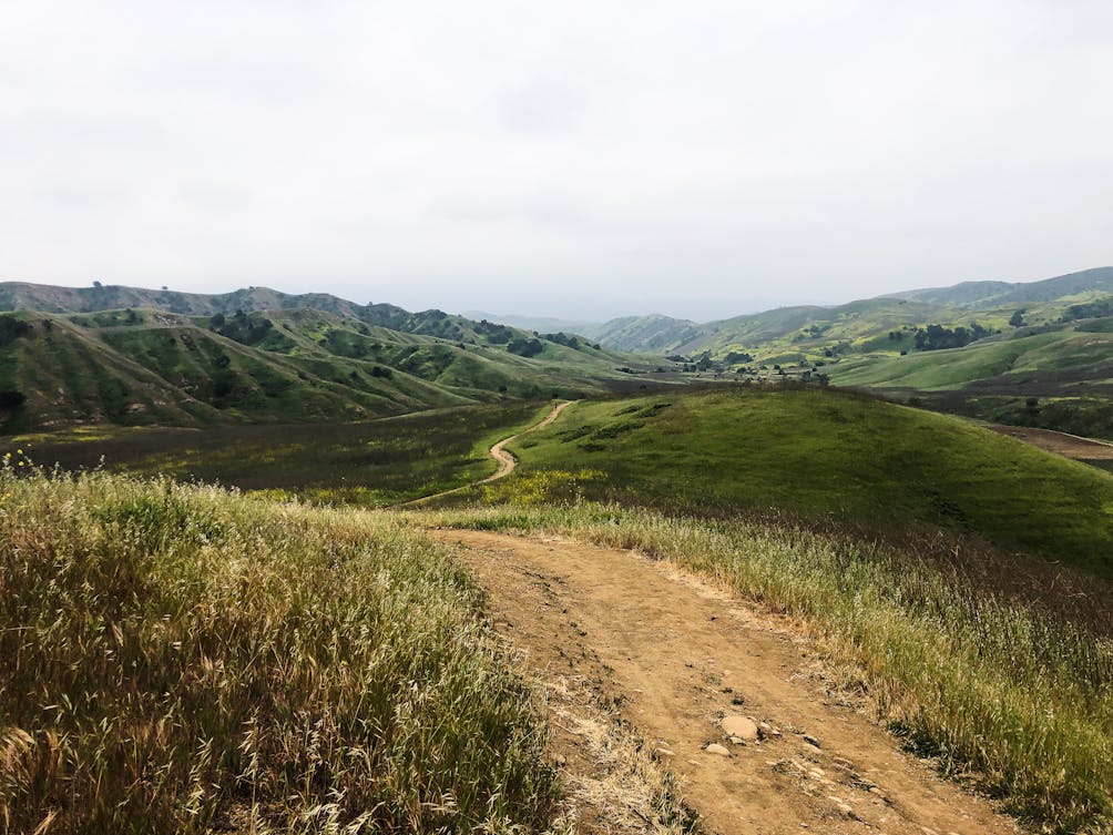 Long wide trail amid hills at Chino Hills State Park in Orange County 