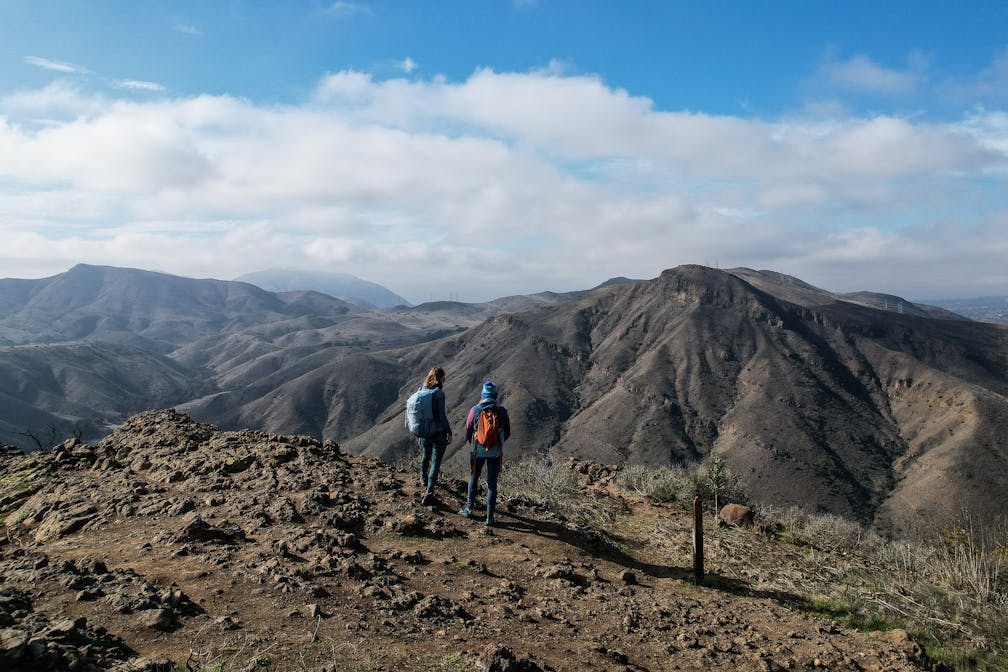 Two Hikers at Wildwood Canyon Overlook Trail in Camarillo there are big mountain views 