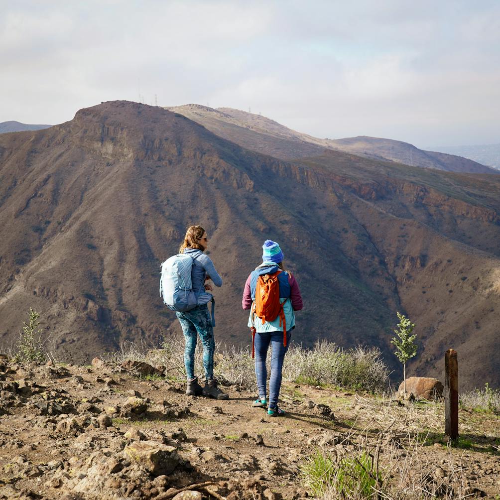 Hikers taking in the big mountain panoramic views at Wildwood Canyon Overlook Trail in Ventura County