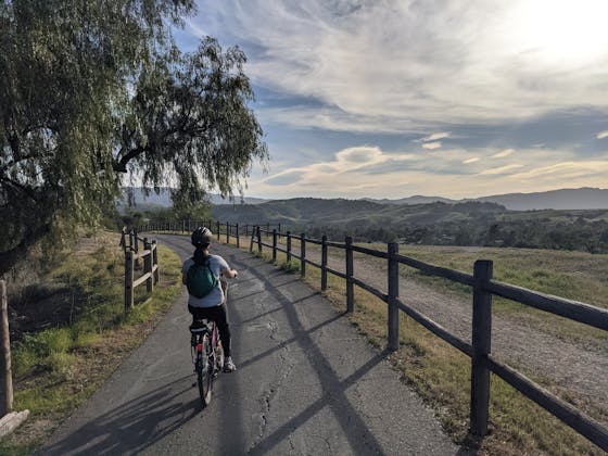 Woman biking the riverside bike trail from Ventura to Ojai