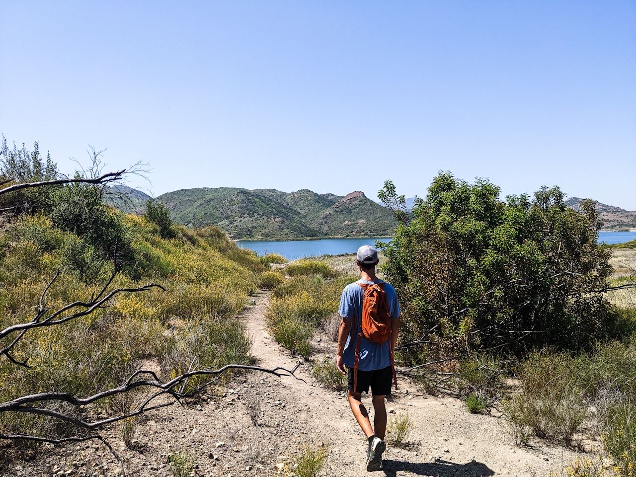 A hiker heading towards Las Virgenes Reservoir at Triunfo Creek Park near Thousand Oaks 