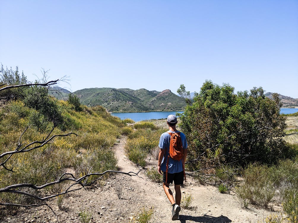 A hiker heading towards Las Virgenes Reservoir at Triunfo Creek Park near Thousand Oaks 