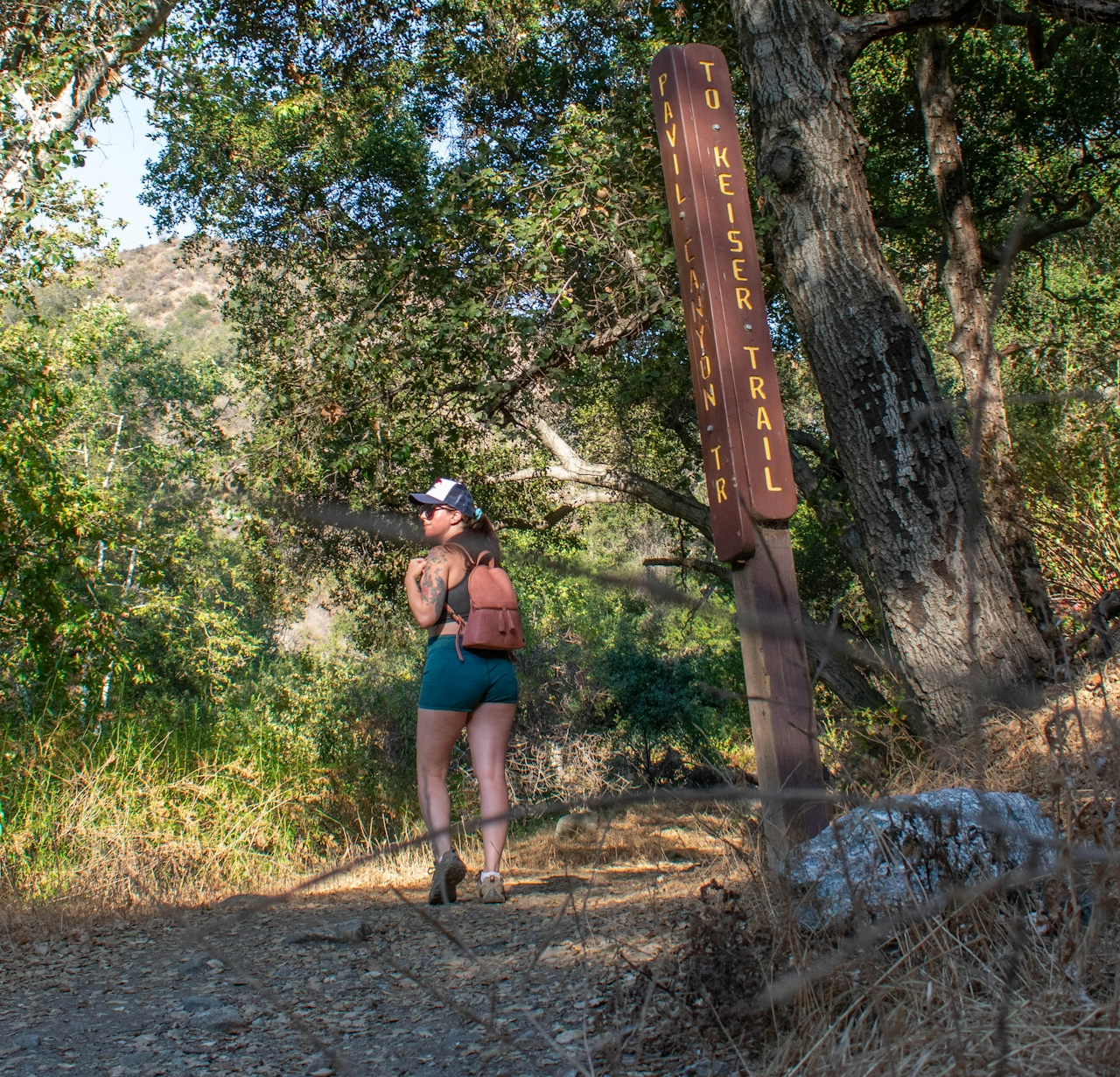 Woman hiking in a forest on the Keiser Trail in Big Dalton Canyon Wilderness Park in Los Angeles County