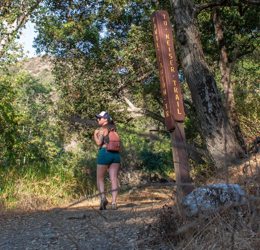 Woman hiking in a forest on the Keiser Trail in Big Dalton Canyon Wilderness Park in Los Angeles County