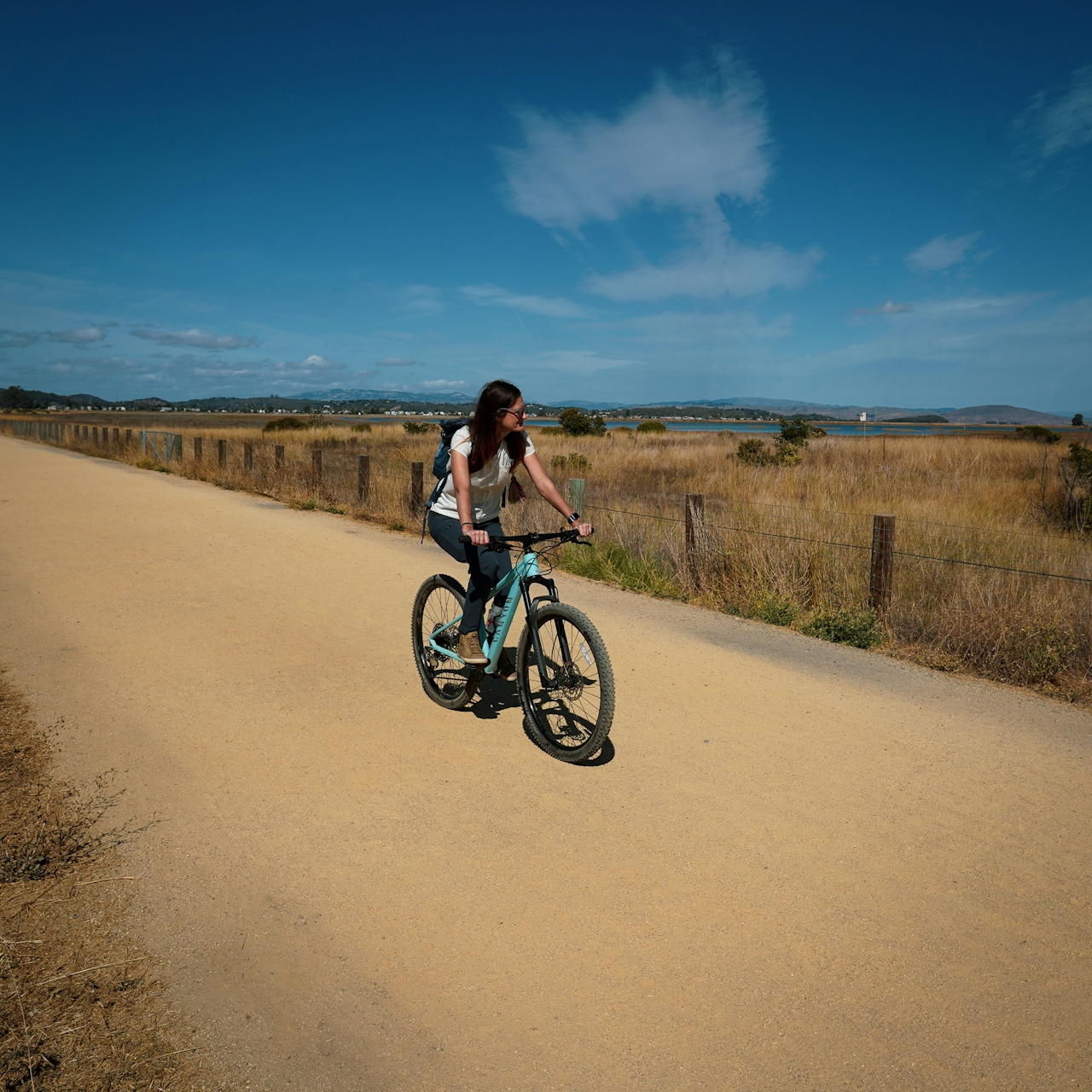 Woman riding her bike at Hamilton Wetlands in Novato 