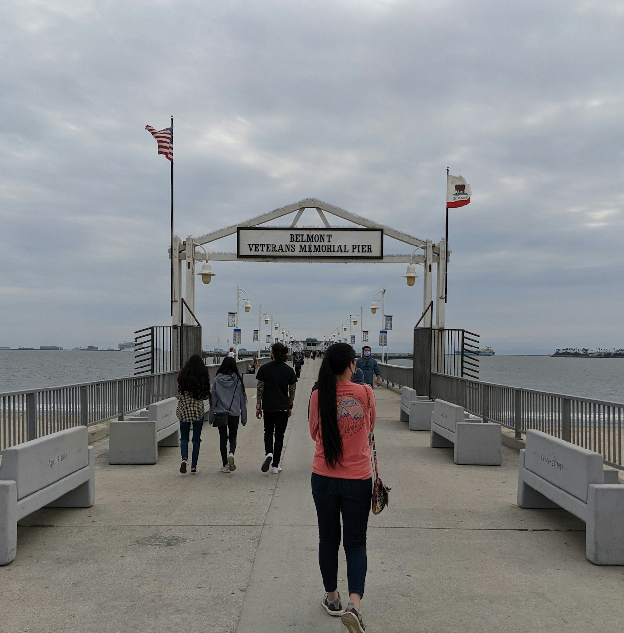 Woman walking at Belmont Pier Memorial in Long Beach 