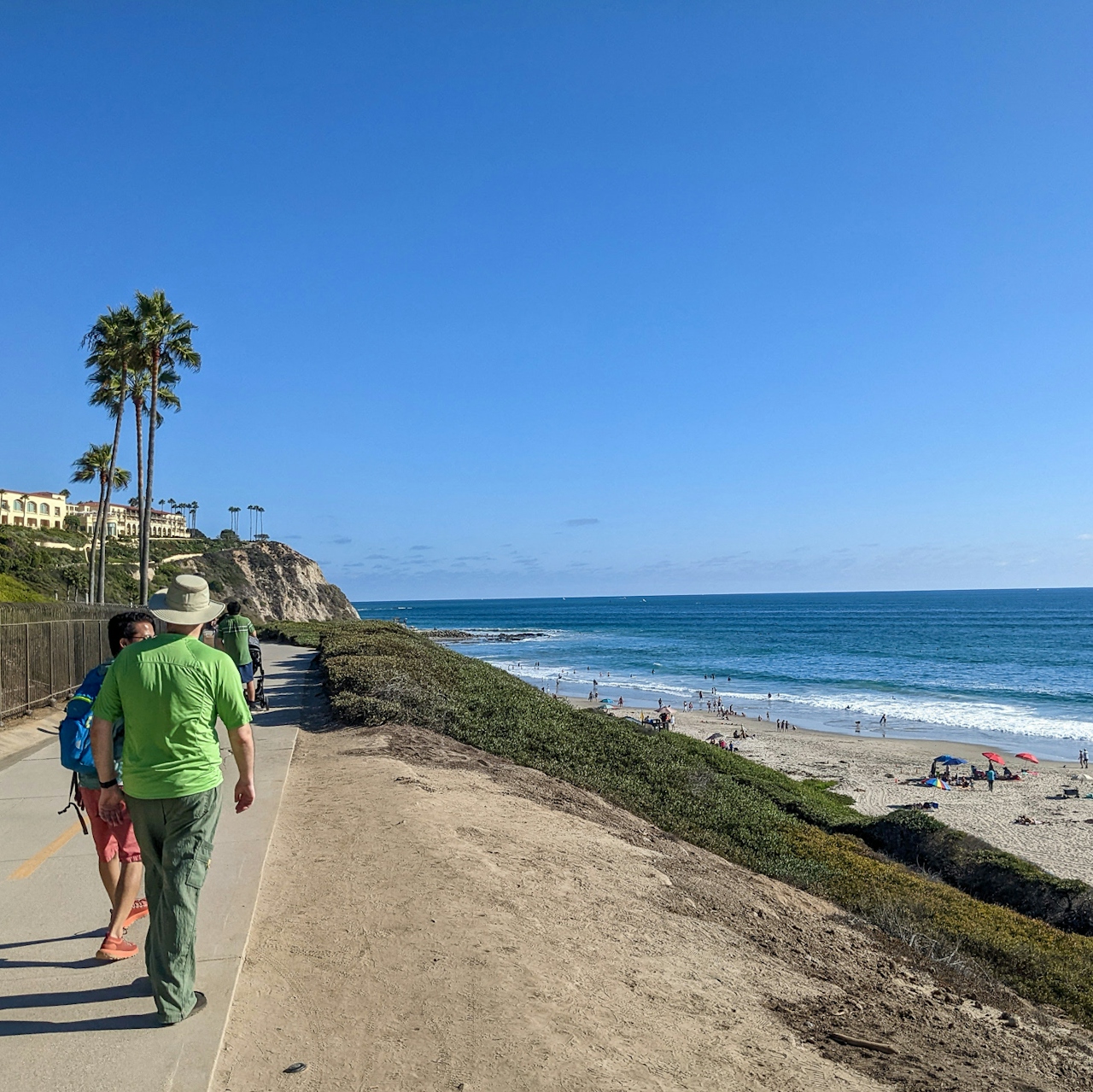 Two people walking along a path next to Salt Creek Beach in Dana Point Southern California 