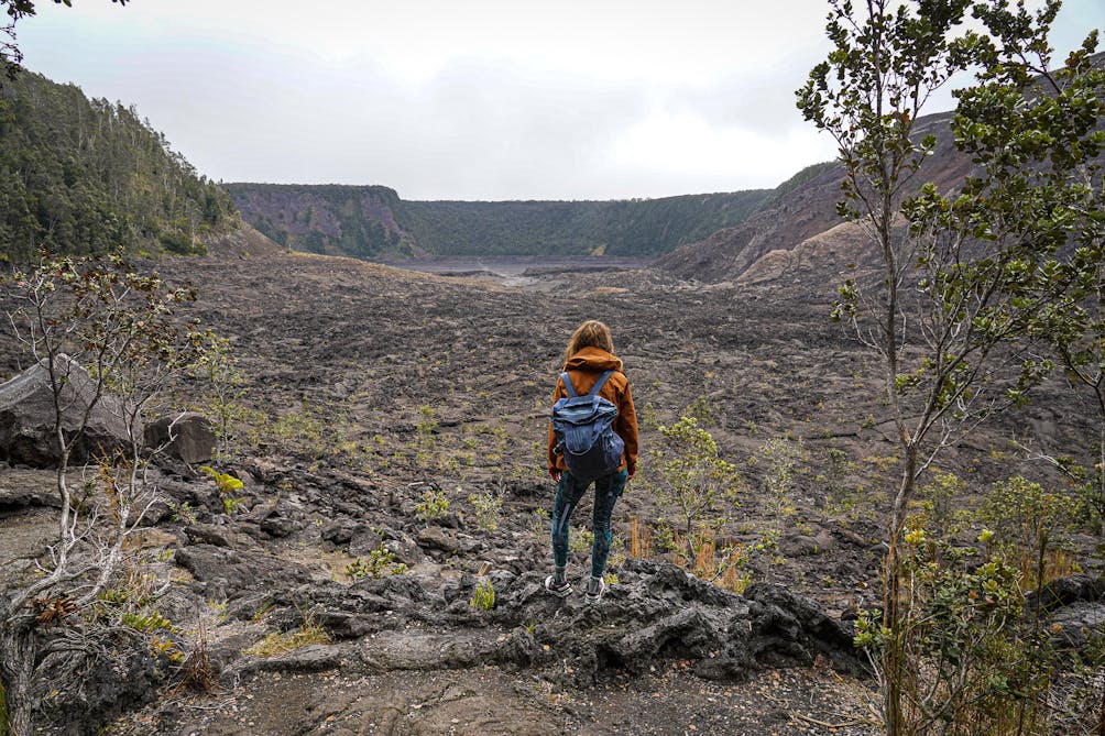 Hiker overlooking the lava field at Hawaii Volcanoes National Park