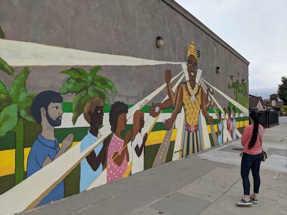 Woman standing an looking at mural wall art in Cambodia Town Long Beach Los Angeles
