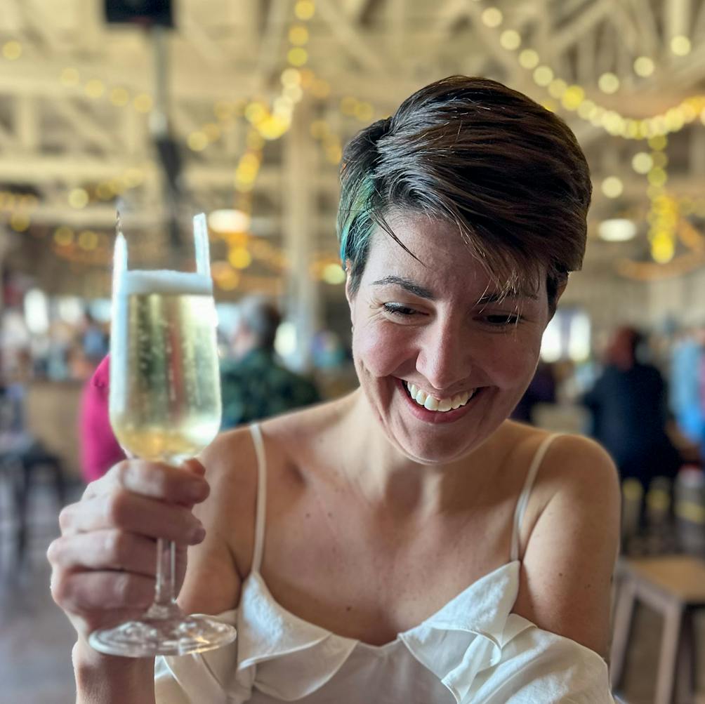 Young woman tasting sparkling wine at Riggers Loft in the historic Richmond Shipyard 