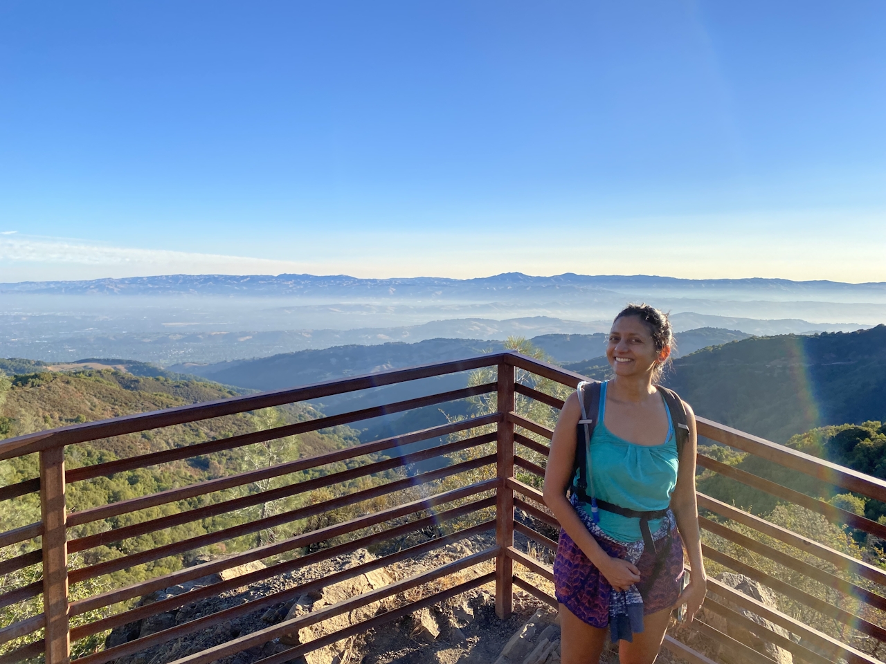 Hiker smiling at the platform summit of Mount Umunhum in the South Bay Santa Cruz Mountains 