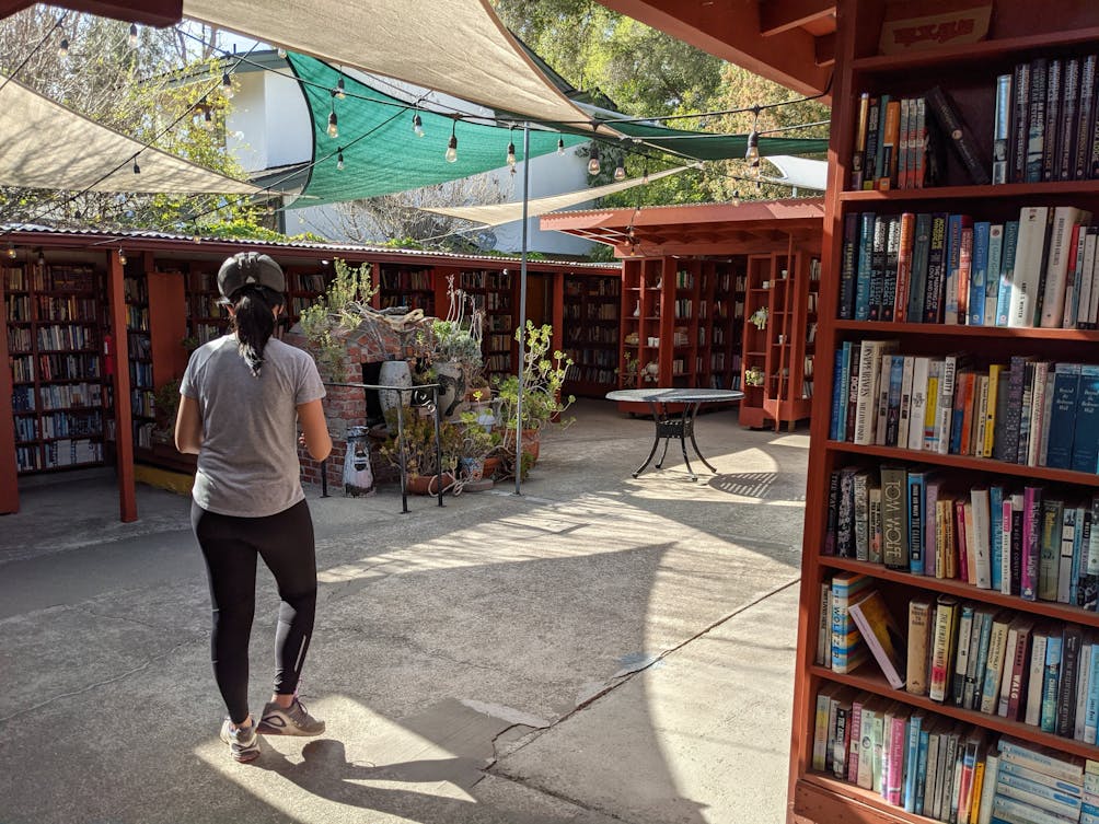 Woman walking around looking at the books in the outdoor bookstore Barth's Books in Ojai California